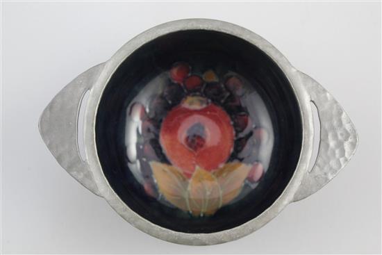 A Moorcroft pomegranate and Tudric pewter mounted quaich, 1920s, 13.8cm